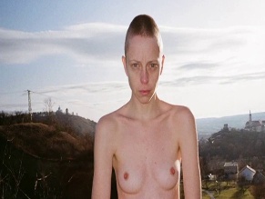 M. M. TOMANOVA NUDE/SEXY SCENE IN WORLD BETWEEN US